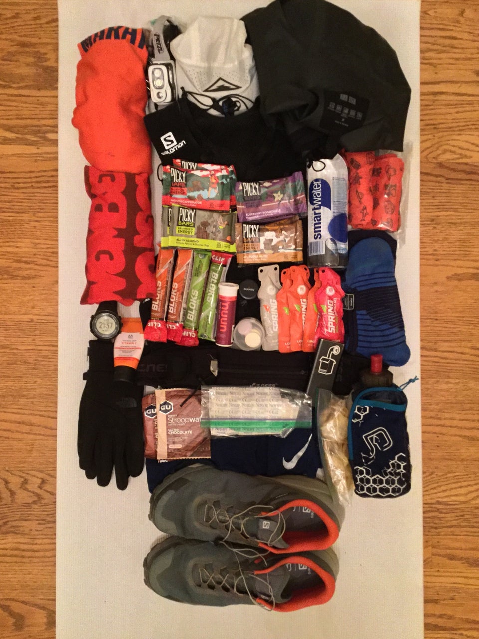 Race kit laid out on a yoga mat.